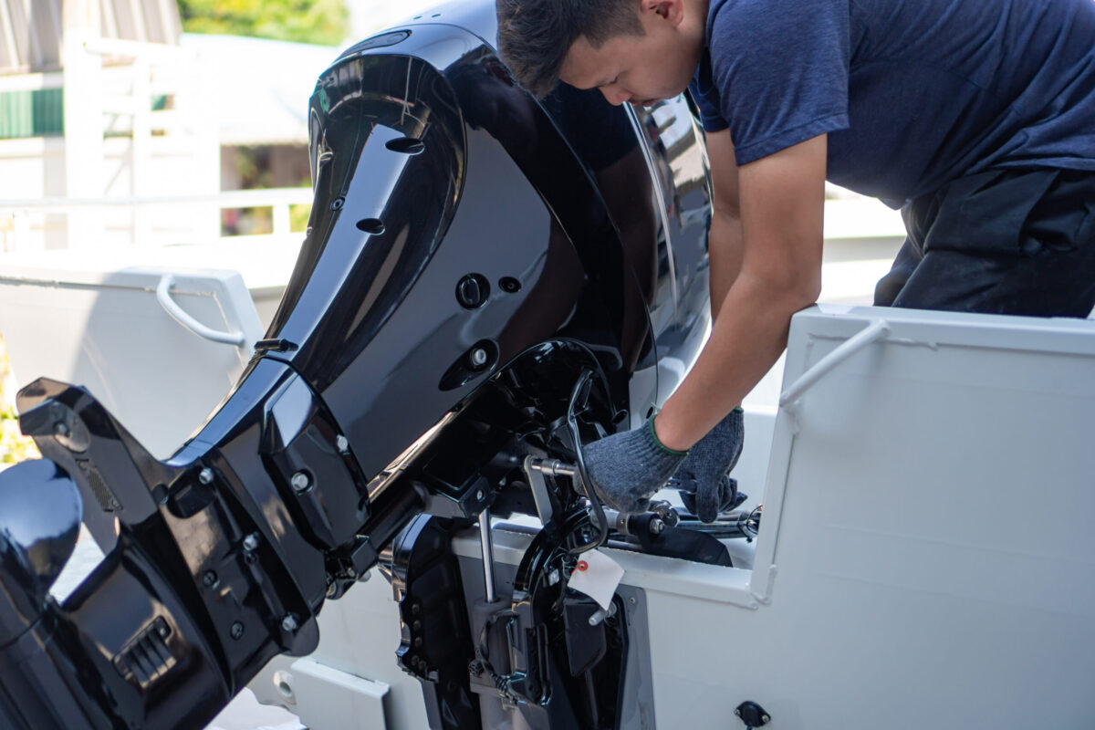 person working on boat motor